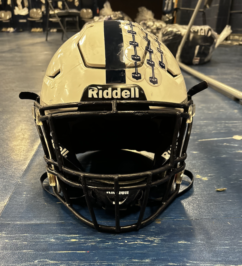 Staples football sporting their normal helmets. Many professional players and high school athletes feel that wearing a guardian cap during practice will ensure better safety for the players during the real games. (Photo by Katherine Phelps '25)